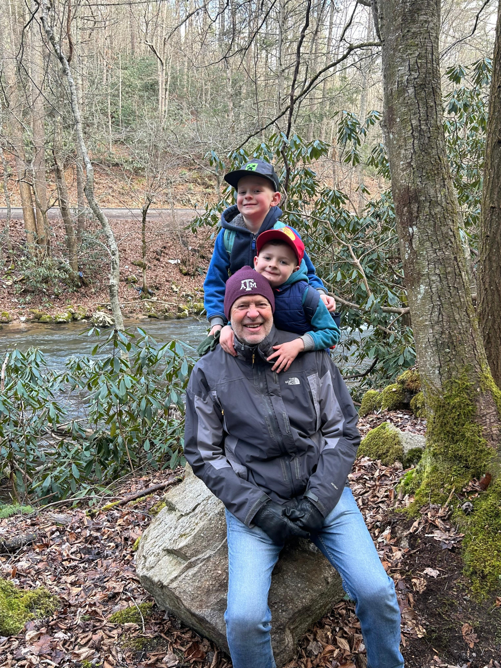 Robert with two of his grandkids on a camping trip